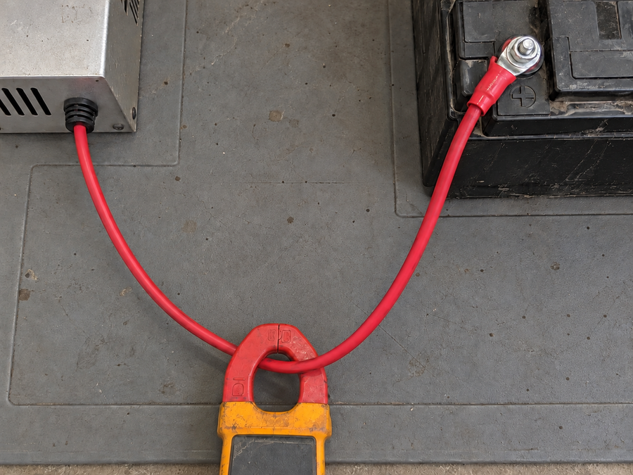 Clamp jaws around a continuous charging cable between charger and battery